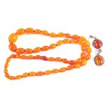 An Amber type butterscotch bead necklace together with a pair of white metal and Amber earrings