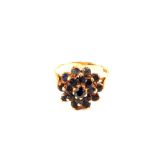 A 9ct Gold ring set with multiple Sapphire stones in flower form,