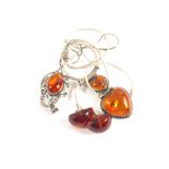 Three pieces of Silver mounted Amber set jewellery consisting of two necklaces and a pair of stud