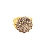 An unmarked Gold ring with abstract shoulders set with large Diamond cluster,