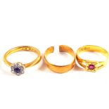 Three 22ct Gold rings, one ring converted from a wedding band with a small red stone,