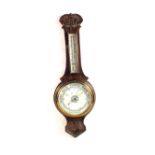 A carved Oak banjo barometer (defective glass)