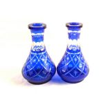 A pair of Bohemian blue glass overlaid carafes