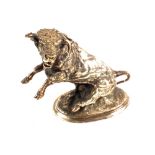 A silvered Bronze figure of a bull with sword in its back,