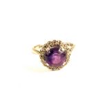 An 18ct White Gold ring set with Amethyst and Diamond surround,