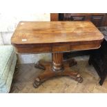 A 19th Century Rosewood folding top tea table on turned and fluted column and platform base on claw