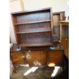 A reproduction mahogany Serpentine front sideboard and an open bookcase
