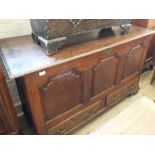 An 18th Century oak mule chest with three carved panels and two drawers below