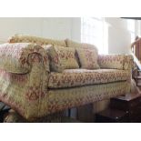 A Multiyork three piece suite in gold and terracotta comprising a three seat sofa,