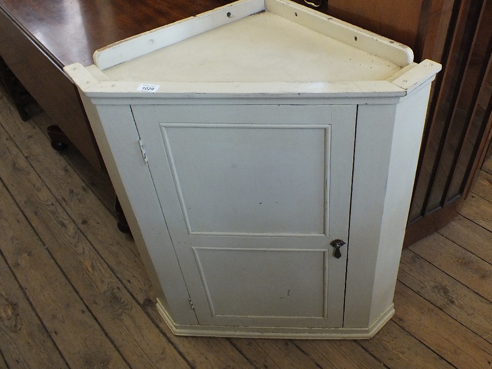 A painted corner cabinet
