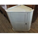 A painted corner cabinet