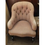 A Victorian button back cream upholstered nursing chair on turned legs