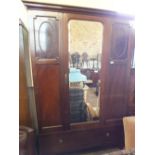 An Edwardian mahogany mirror door wardrobe