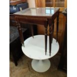 A vintage white tulip table marked Arkana and a nest of two inlaid mahogany glass top tables