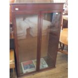 A mahogany floor standing two door glazed bookcase