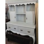 A pale green painted oak shelf back cupboard with two drawers on cabriole legs