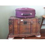 A modern metal bound trunk and a mauve suitcase set