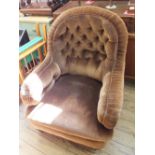 A Victorian armchair in button back brown draylon