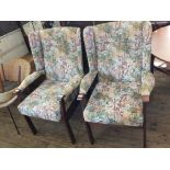 A pair of modern floral upholstered arm wingback armchairs
