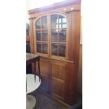 A large pine corner cupboard with two astral glazed doors over two cupboard doors below