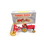 A boxed Dinky toys 310 Massey Harris farm tractor and hay rake in box type 2