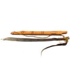 A 19th Century Bayak head-hunters sword with scabbard (the carved grip as found)