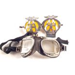 A pair of stadium motorcycle goggles plus two AA badges