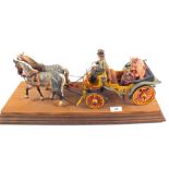 A model two horse open carriage with driver and lady with parasol