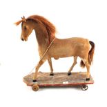 A stuffed miniature pony model on wooden base,