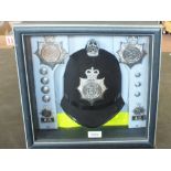 A Dorset Police helmet mounted in custom display case with various Dorset badges and buttons