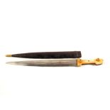 An ethnic double edged dagger in its leather sheath
