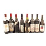 A wine rack containing various wines, Viz Chianti, Valpolicella, Bergerac 1997,