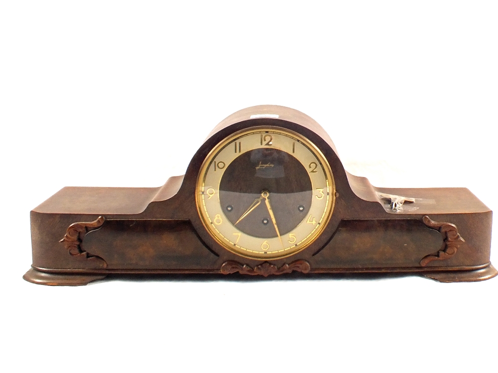 An oak cased striking mantel clock