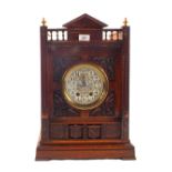 A large oak Gothic style bracket clock with painted enamel dial