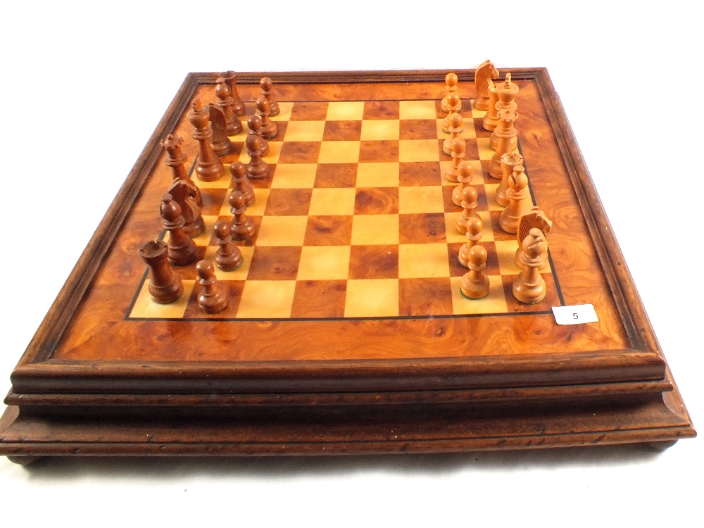 A wooden chess board and set