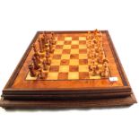 A wooden chess board and set