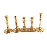 Two early 18th Century side ejector brass candlesticks,