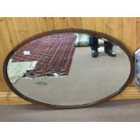 Two oval mahogany wall mirrors plus three others