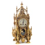 A gilt metal architectural mantel clock