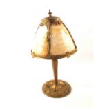 A gilt metal table lamp with slag glass shade