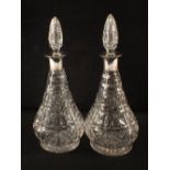 A pair of silver rim cut glass decanters,