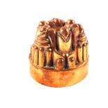 A Victorian circular copper jelly mould of six turret castle form,