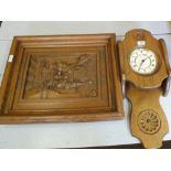 A pair of continental carved figural panels with a wooden mounted time piece