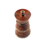 An oak and silver banded pepper grinder