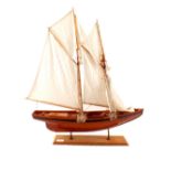 A model ship titled 'Bluenose' in full sail on stand