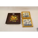 A Minton & Hollins relief fruit moulded tile plus two Maw & Co blue floral tiles