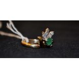 An 18ct gold emerald and diamond ring,