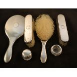 A silver four piece brush and mirror set,