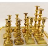 Six pairs of Victorian brass candlesticks,