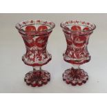 A pair of 19th Century Bohemian red flashed stag, figure and floral vases (one light top rim chip),